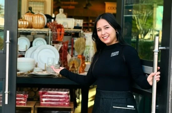 Sur La Table employee wearing apron at store entrance